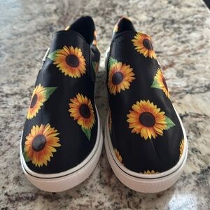 Brand new women’s size 9 sunflower slip on shoes black and gold